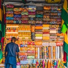 African man with fabric in market ; Shutterstock ID 1486027394; your: Brian Healy; gl: 65050; netsuite: Lonely Planet Online Editorial; full: Best times to visit Ghana